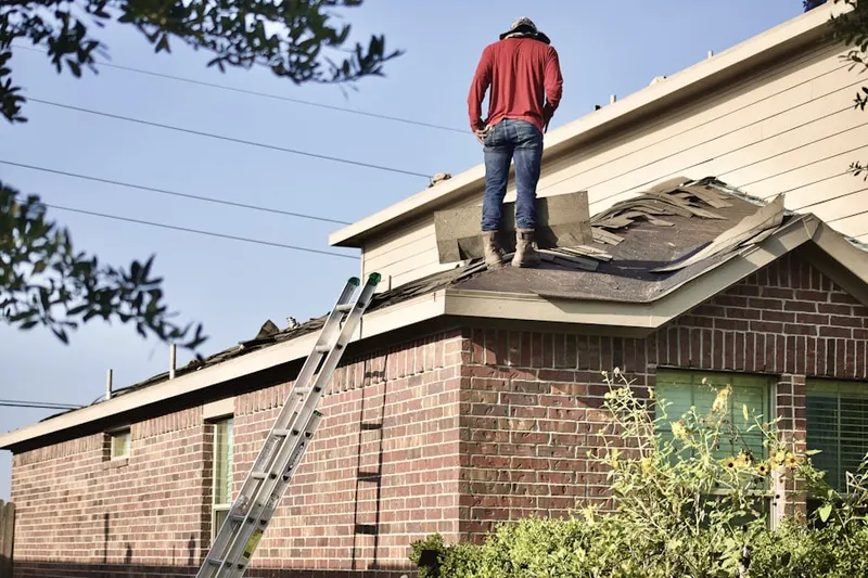 Professional roofer working on a residential roof in Nyes Neck